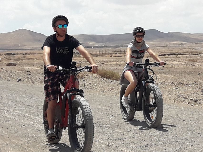Caleta de Fuste/Corralejo: Guided E-Bike Tour & Crater Hike - The morning rhythm: pick-up, bus ride, and first guided stops